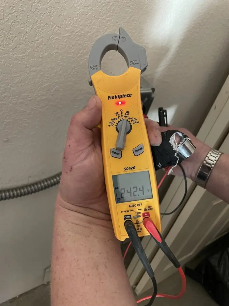 Voltage testing with clamp meter during Electrical Installation Services in Otsego